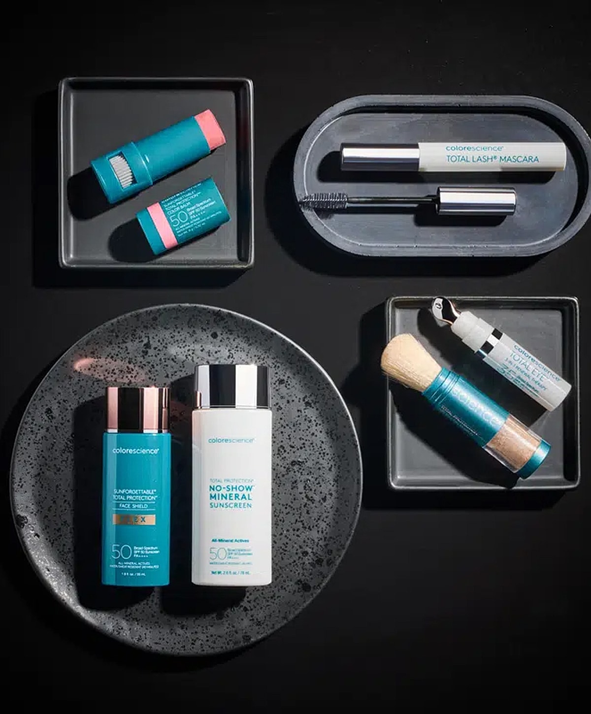 Color science skincare products on dark background.