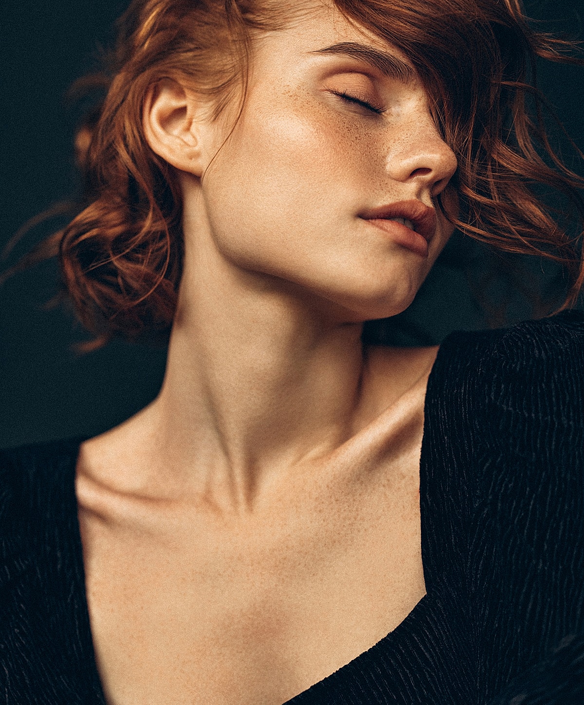 Close-up portrait of a woman with red hair.