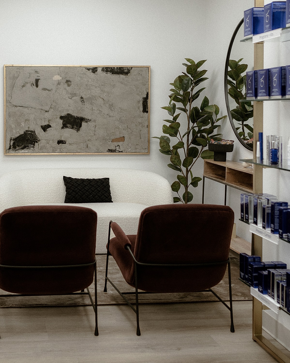 Modern waiting room with green couch and mirror.