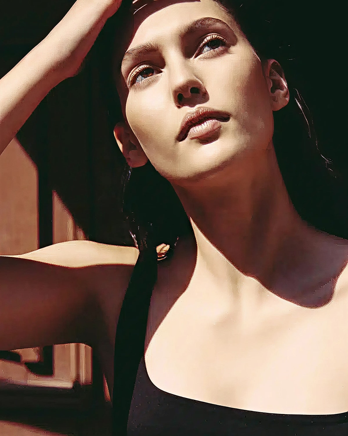 Model posing with natural light and soft shadows.
