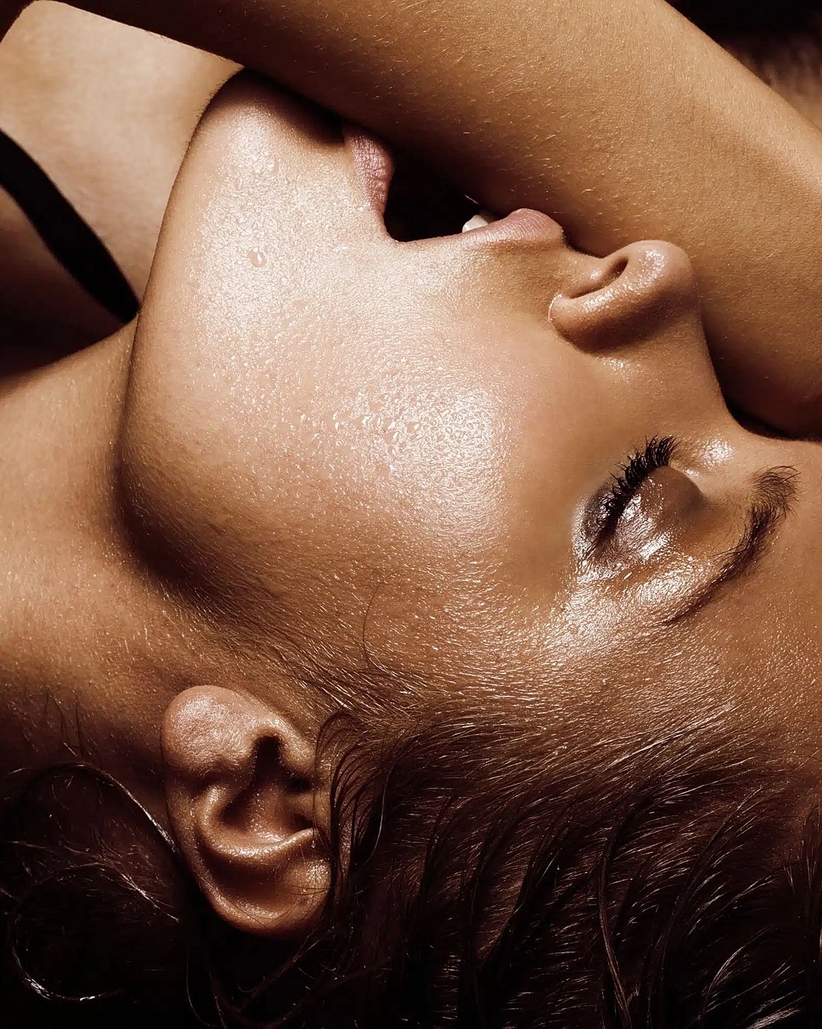 Close-up of a woman's face and shoulder.