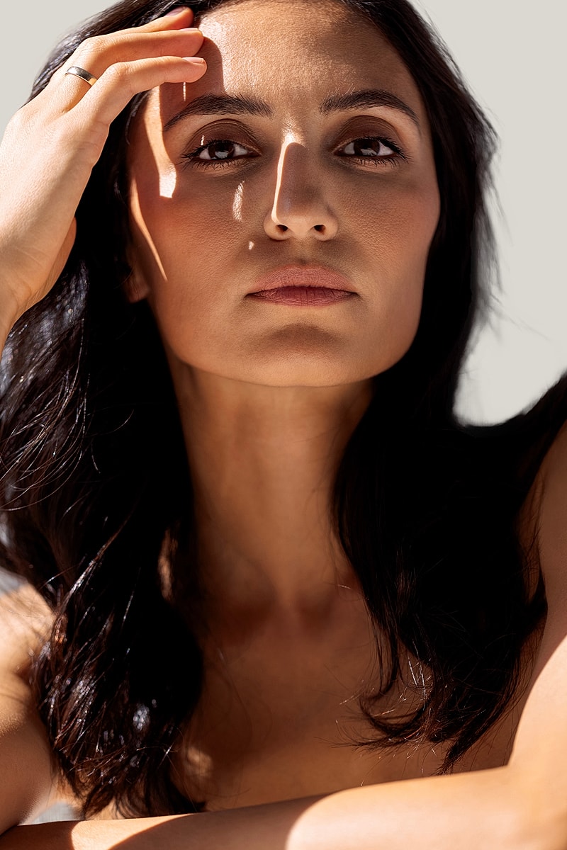 Woman with long hair, natural light portrait.
