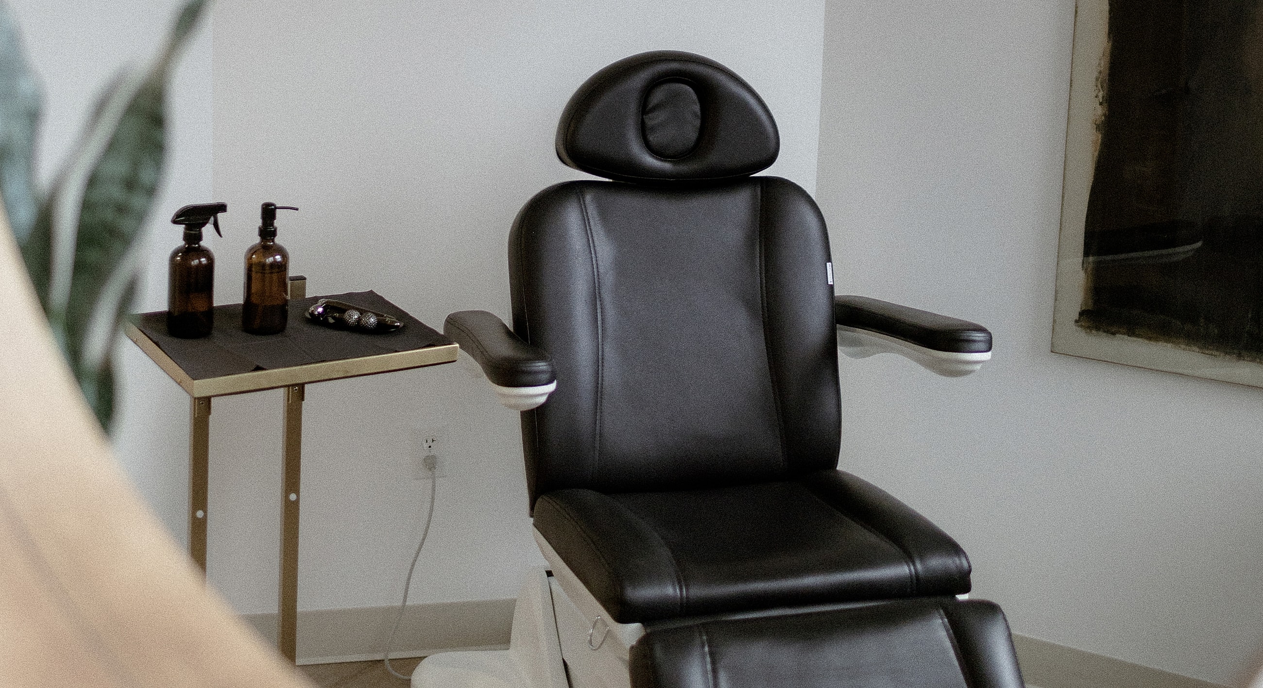 Medical examination room with chair and bright light.