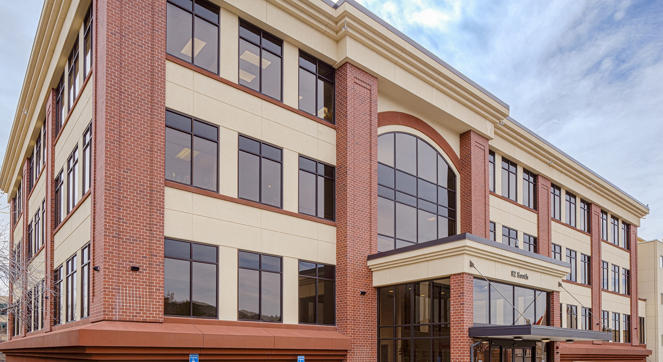 Modern brick office building with large windows.