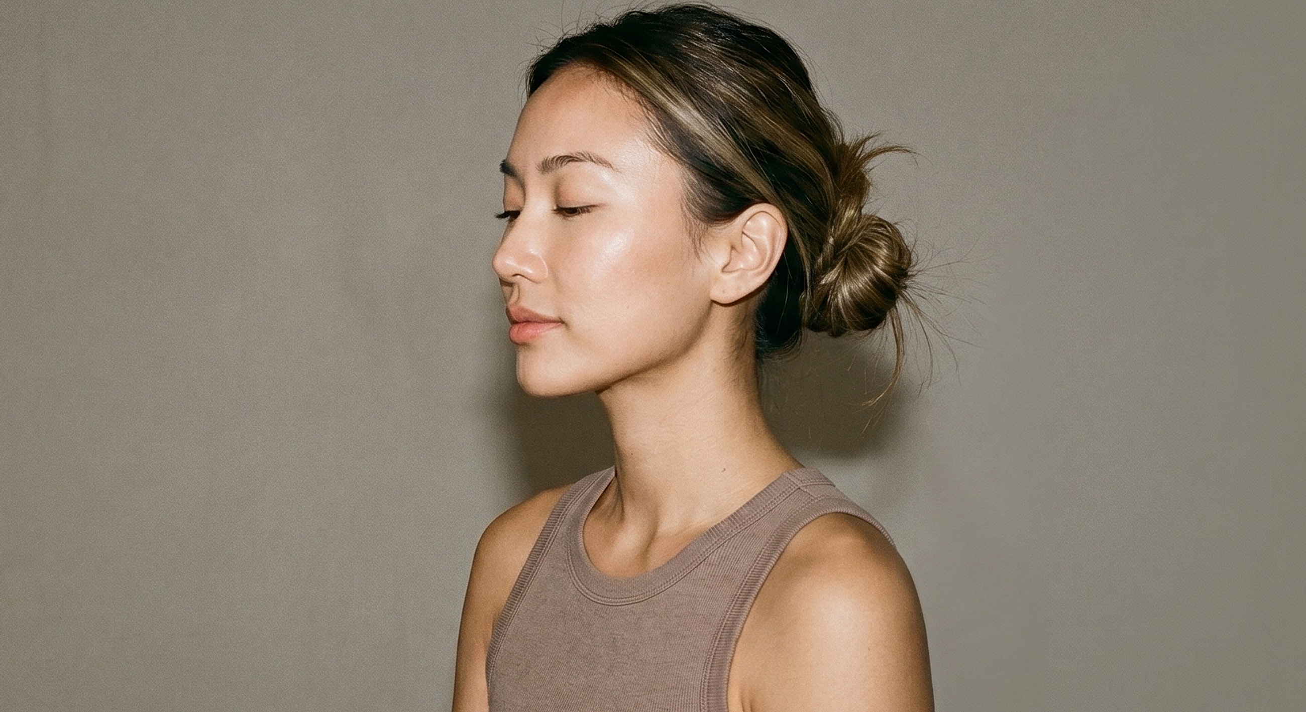 Profile of a woman with a bun hairstyle.
